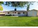 This expansive backyard with lush grass features mature trees and single-story home at 4314 E Montecito Ave, Phoenix, AZ 85018