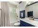Bathroom features a bathtub, shower, toilet, vanity, decorative painting, and stylish oval mirror at 4314 E Montecito Ave, Phoenix, AZ 85018