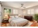 Bright bedroom featuring a cozy rug, neutral palette, plantation shutters, and stylish furnishings at 4314 E Montecito Ave, Phoenix, AZ 85018