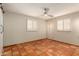 Bedroom features terracotta floors, recessed lighting, and white window shutters providing a soothing ambiance at 4314 E Montecito Ave, Phoenix, AZ 85018