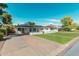Well-maintained home with a large driveway, green lawn, and freshly painted white exterior at 4314 E Montecito Ave, Phoenix, AZ 85018