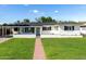 Charming single-story home with lush green lawn, brick walkway, and freshly painted white exterior at 4314 E Montecito Ave, Phoenix, AZ 85018