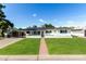 Charming single-story home with lush green lawn, brick walkway, and freshly painted white exterior at 4314 E Montecito Ave, Phoenix, AZ 85018