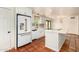 Spacious kitchen featuring white cabinets and appliances, plus a central island, all illuminated by natural light at 4314 E Montecito Ave, Phoenix, AZ 85018