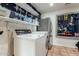Updated laundry room with newer appliances, overhead shelves and Saltillo tile flooring at 4314 E Montecito Ave, Phoenix, AZ 85018