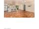 Open-concept living room with tile flooring flowing into a bright kitchen with a breakfast bar and white cabinets at 4314 E Montecito Ave, Phoenix, AZ 85018