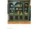 A green shelving unit displays decor above terracotta floors in this cozy and welcoming living room at 4314 E Montecito Ave, Phoenix, AZ 85018