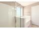 Bathroom featuring a glass enclosed shower and tub with window for natural light at 4347 W Darrel Rd, Laveen, AZ 85339