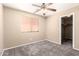 Beige bedroom with a window, ceiling fan, carpet and a closet at 4347 W Darrel Rd, Laveen, AZ 85339