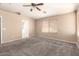 Spacious carpeted bedroom with a vaulted ceiling and ample natural light at 4347 W Darrel Rd, Laveen, AZ 85339