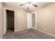 Comfortable bedroom with carpet, ceiling fan, and closet access at 4347 W Darrel Rd, Laveen, AZ 85339