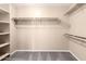 Walk-in closet featuring shelves, hanging racks, and carpeted floors at 4347 W Darrel Rd, Laveen, AZ 85339