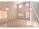 Bright living room with high ceilings, large windows, and tile flooring at 4347 W Darrel Rd, Laveen, AZ 85339