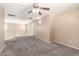 Open loft area with plush carpet, ample natural light, and views of the staircase at 4347 W Darrel Rd, Laveen, AZ 85339