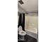 Bright bathroom featuring a shower-tub combo with black shower curtains at 5311 W Fulton St, Phoenix, AZ 85043