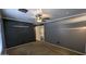 Bedroom featuring gray walls, a ceiling fan, and access to the bathroom at 5311 W Fulton St, Phoenix, AZ 85043