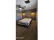 Bedroom featuring a wood accent wall, ceiling fan, and carpeted floors at 5311 W Fulton St, Phoenix, AZ 85043