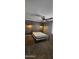 Bedroom featuring a wood accent wall, ceiling fan, and carpeted floors at 5311 W Fulton St, Phoenix, AZ 85043