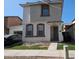 Two story home with tan stucco and brown trimmed windows and door at 5311 W Fulton St, Phoenix, AZ 85043