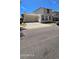 Two story home with attached garage, tan stucco and brown trimmed windows and door at 5311 W Fulton St, Phoenix, AZ 85043