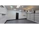 Clean garage featuring epoxy flooring, bright lighting, and convenient access door at 5311 W Fulton St, Phoenix, AZ 85043