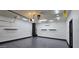 Garage space with epoxy flooring, mini-split AC, and storage shelves, offering a clean, functional design at 5311 W Fulton St, Phoenix, AZ 85043