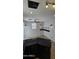 Kitchen area with granite counters, black cabinets, beverage bar, and ceiling fan at 5311 W Fulton St, Phoenix, AZ 85043