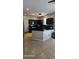 Bright kitchen with dark cabinets and counters, modern appliances, and tile floors at 5311 W Fulton St, Phoenix, AZ 85043