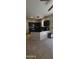 Open concept kitchen with dark cabinets, stylish counters, and tile floors at 5311 W Fulton St, Phoenix, AZ 85043