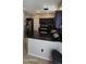 Updated kitchen featuring dark cabinets, granite counters, modern appliances, and tile floors at 5311 W Fulton St, Phoenix, AZ 85043