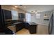 Beautiful kitchen featuring dark cabinets, tiled floor, and stainless steel appliances perfect for entertaining at 5311 W Fulton St, Phoenix, AZ 85043