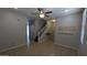 Spacious living room with tile floors, neutral paint, recessed lighting, a ceiling fan, and access to the staircase at 5311 W Fulton St, Phoenix, AZ 85043