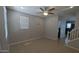 Bright living room featuring tile floors, neutral paint, recessed lights, a ceiling fan, and a view of the staircase at 5311 W Fulton St, Phoenix, AZ 85043