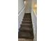 Staircase with neutral carpet and white handrail leads to the upper level at 5311 W Fulton St, Phoenix, AZ 85043