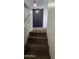 Carpeted staircase leading to the upper level with modern black sliding closet doors at 5311 W Fulton St, Phoenix, AZ 85043