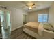 Bedroom featuring wood-look floors, updated fan, and sliding closet door at 555 N May -- # 1, Mesa, AZ 85201