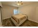 Bedroom with wood-look floors, new fan, and large window at 555 N May -- # 1, Mesa, AZ 85201