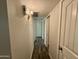 Hallway with neutral walls and trim leading to several rooms at 555 N May -- # 1, Mesa, AZ 85201