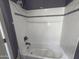 Clean and bright bathroom featuring white tiles and a new showerhead at 6506 S 50Th Ln, Laveen, AZ 85339