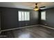 Bedroom with wood floors, fan and plantation shutters at 6506 S 50Th Ln, Laveen, AZ 85339