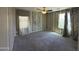 Spacious bedroom features carpet, neutral striped wall paint, and a ceiling fan with light at 6506 S 50Th Ln, Laveen, AZ 85339
