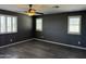 Bedroom with wood floors, fan and plantation shutters at 6506 S 50Th Ln, Laveen, AZ 85339