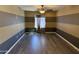 Spacious bedroom with neutral-colored wall stripes, hard floors, and a ceiling fan at 6506 S 50Th Ln, Laveen, AZ 85339