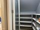 Walk-in closet with shelving for ample storage and organization at 6506 S 50Th Ln, Laveen, AZ 85339