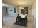 Elegant dining area with a modern table and chairs, and natural light at 6506 S 50Th Ln, Laveen, AZ 85339