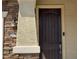 Elegant front door with stone accents, creating a welcoming entry to this beautifully designed home at 6506 S 50Th Ln, Laveen, AZ 85339