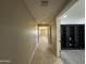 Hallway leading to an office space with built-in shelving and wood floors at 6506 S 50Th Ln, Laveen, AZ 85339