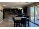 Bright and spacious kitchen with dark cabinets, stainless steel appliances, island, and adjacent dining area at 6506 S 50Th Ln, Laveen, AZ 85339