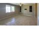 Neutral living room with tile floors, ceiling fan and views of the well maintained backyard and patio at 6506 S 50Th Ln, Laveen, AZ 85339