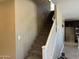 Carpeted staircase with white railing that is located near the kitchen at 6506 S 50Th Ln, Laveen, AZ 85339